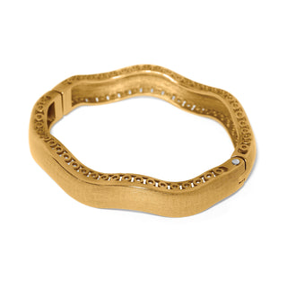 Brighton gold-tone wide hinged bangle bracelet with wavy silhouette and circular cutout trim