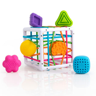 Fat Brain Toys InnyBin shape sorter cube with colorful elastic bands and six textured shapes