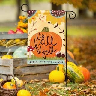 It's Fall Y'all garden flag featuring pumpkin, mushroom, and acorns displayed outdoors among gourds