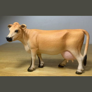 Model of a cow on a wooden surface 