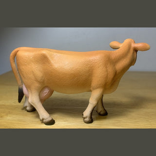 Model of a cow on a wooden surface 