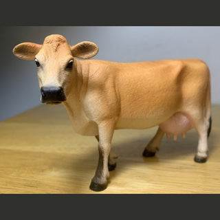 Model of a cow on a wooden surface 