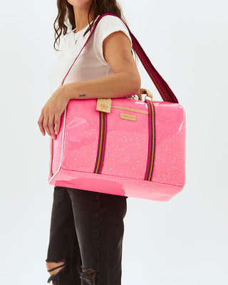 Model carrying large neon pink glitter Consuela Jet Setter duffle bag on shoulder