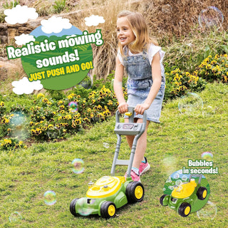 Toddler girl pushing John Deere green and yellow bubble lawn mower with bubbles in grass