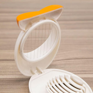 Close-up of parallel stainless steel wires in open white penguin egg slicer
