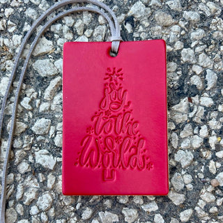 Red leather air freshener tag embossed with Joy to the World Christmas tree design
