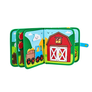 Joycat Farm Animal Kids Busy Book open showing barn, tractor, and apple tree pages