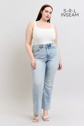 Judy Blue light wash bootcut jeans styled with white tank top on plus-size model