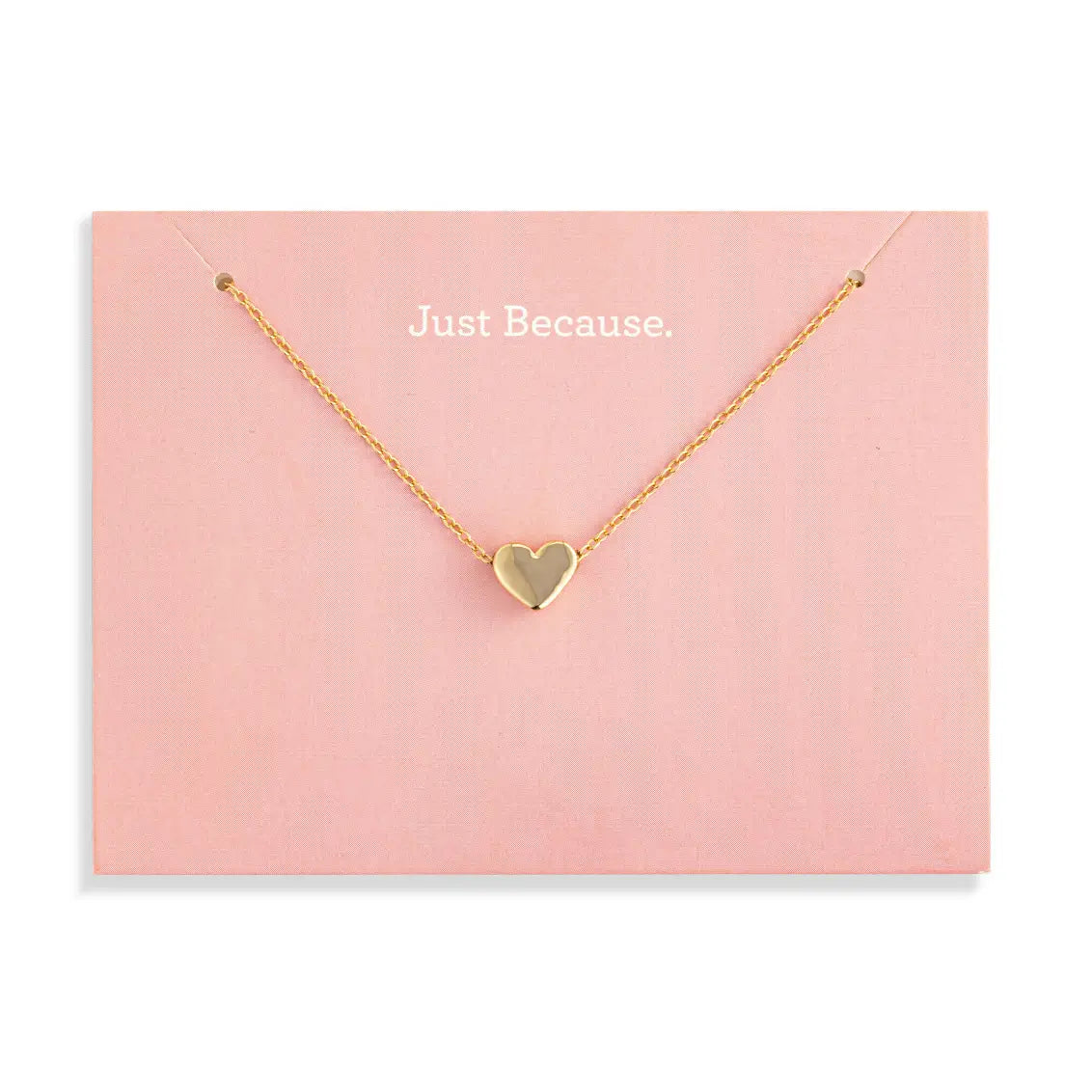 Gold heart necklace on a pink card with 'Just Because' text