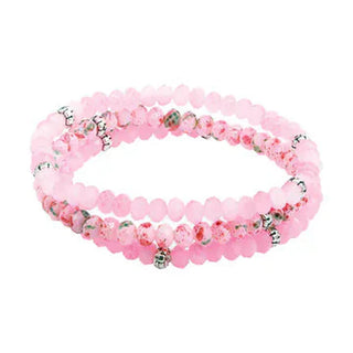 Pink beaded bracelet stack for girls with frosted beads and silver bell charm