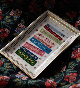 Rifle Paper Co. porcelain catchall tray featuring classic literary book titles on floral fabric background