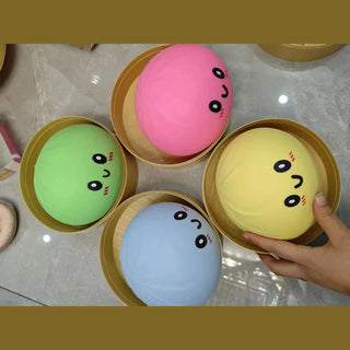 four pack of pink green blue yellow dumpling squishy toys in wooden steamers