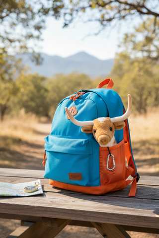 Larry the Texas Longhorn in backpack pocket ready for adventure