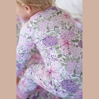 Close-up back detail of lavender hydrangea and pink bow print on stretchy bamboo romper