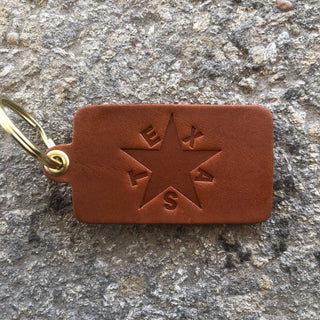 Brown leather key tag with embossed Texas star and brass ring