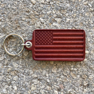 Dark red leather keychain with embossed American flag design and silver split ring