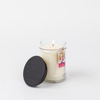 Bridgewater Let's Celebrate small jar candle lit with black wooden lid beside it