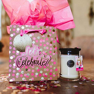 Bridgewater Let's Celebrate small jar candle displayed beside a pink polka dot gift bag with tissue paper