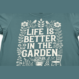Close-up of distressed white 'Life is Better in the Garden' typography on teal-green ring-spun cotton fabric
