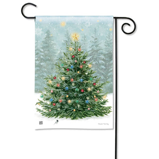 Christmas garden flag featuring decorated tree with colorful ornaments and star topper in snowy scene