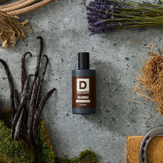 Duke Cannon Palomino cologne bottle with mahogany vanilla scent notes surrounded by vanilla beans and lavender