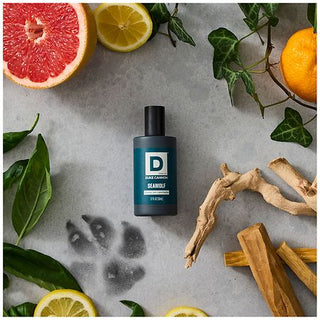 Duke Cannon Seawolf cologne bottle styled with citrus fruits, ginger root, and ivy leaves