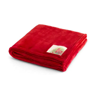 Folded red plush blanket with cardinal bird decorative label patch