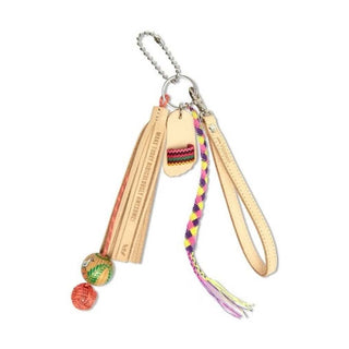 Consuela Lumi Charm bag keychain with multicolored striped leather tag, braided cord, wooden bead, and beige tassel