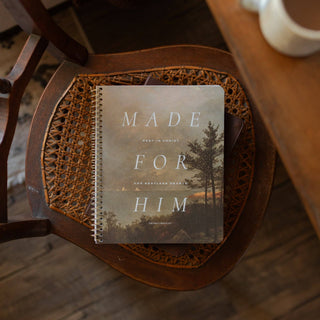 Made for Him spiral Bible study journal on a woven cane wooden chair