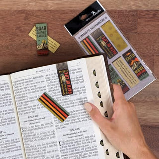 Christian Art Gifts magnetic bookmark set with mountain themes shown in open Bible with packaging