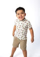 Toddler boy wearing white polo shirt with colorful mallard duck print pattern