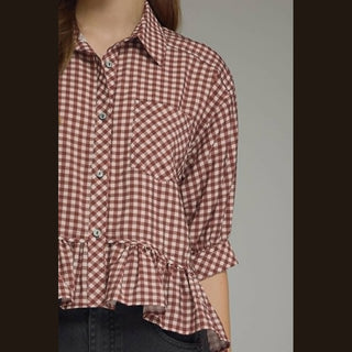 Close-up of brick red and white gingham button front top with chest pocket detail