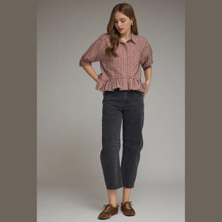 Full body shot of women's maroon gingham shirt with collar and ruffle hem