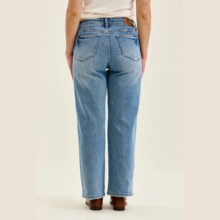 Back view of medium wash straight jeans featuring symmetrical rear pockets and centered seam
