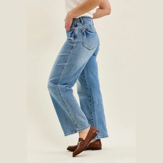 Dynamic pose of petite straight leg jeans highlighting relaxed fit and inseam stitching