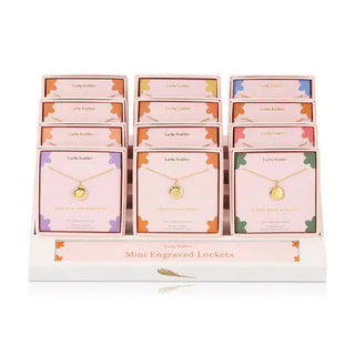 Variety of Lucky Feather Mini Engraved Lockets on retail display with sentiment phrases