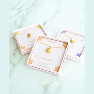 Lucky Feather Mini Engraved Locket in gold with delicate chain and floral packaging