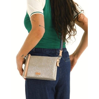 Model in Green and White Shirt Holding Faye Crossbody