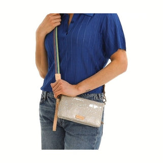 Person holding a beige handbag 