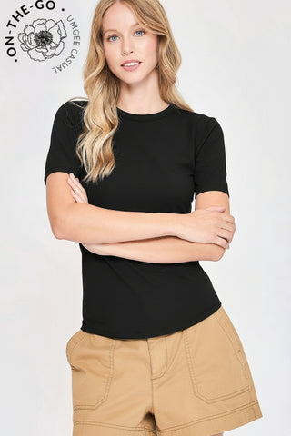 Woman wearing a black t-shirt and beige shorts with 'On The Go' logo in the corner.