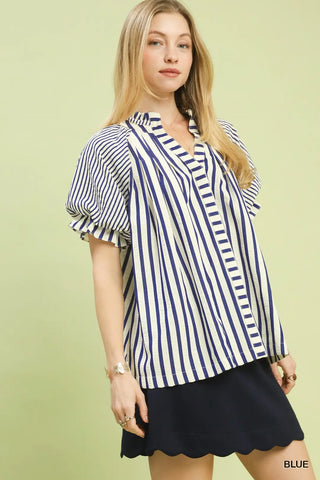 Woman wearing a blue and white striped blouse