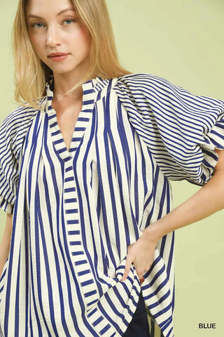 Woman wearing a blue and white striped shirt 