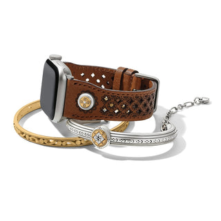 Brown pierced leather smart watch band with floral mosaic cutouts and two-tone ornaments styled with stacked bangles