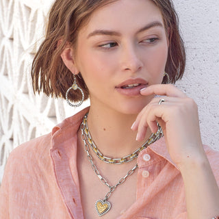 Model wearing Brighton Mosaic Two Tone French Wire Hoop Earrings in silver and gold with layered necklaces