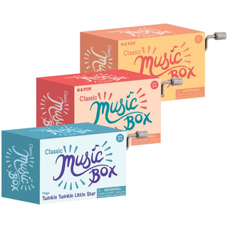 Three Classic Music Box packages in teal, coral, and peach with hand cranks for kids