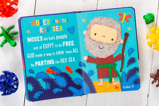 Moses and the Red Sea children's book with stitched gray felt Moses figure holding staff on turquoise pages