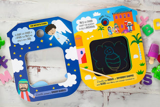 Open children's Bible story book with blue star page, yellow palm tree page, and green bee doodle on LCD