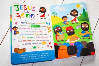 Jesus Feeds 5000 illustrated spread in My First Toddler Bible showing diverse children, bread baskets, and John 6:12-13 reference