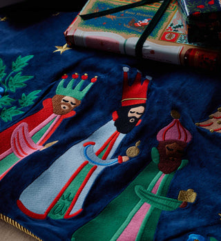 Close-up detail of Rifle Paper Co. Nativity embroidered tree skirt showing Three Wise Men on navy velvet