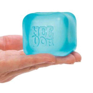 Sky blue semi-translucent NeeDoh cube with glossy finish held to show structural integrity
